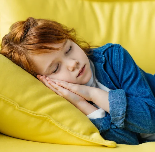 Child sleeping peacefully on a yellow pillow, showing the importance of children’s airway and sleep care at Dream Dental & Sleep in Hermitage, PA